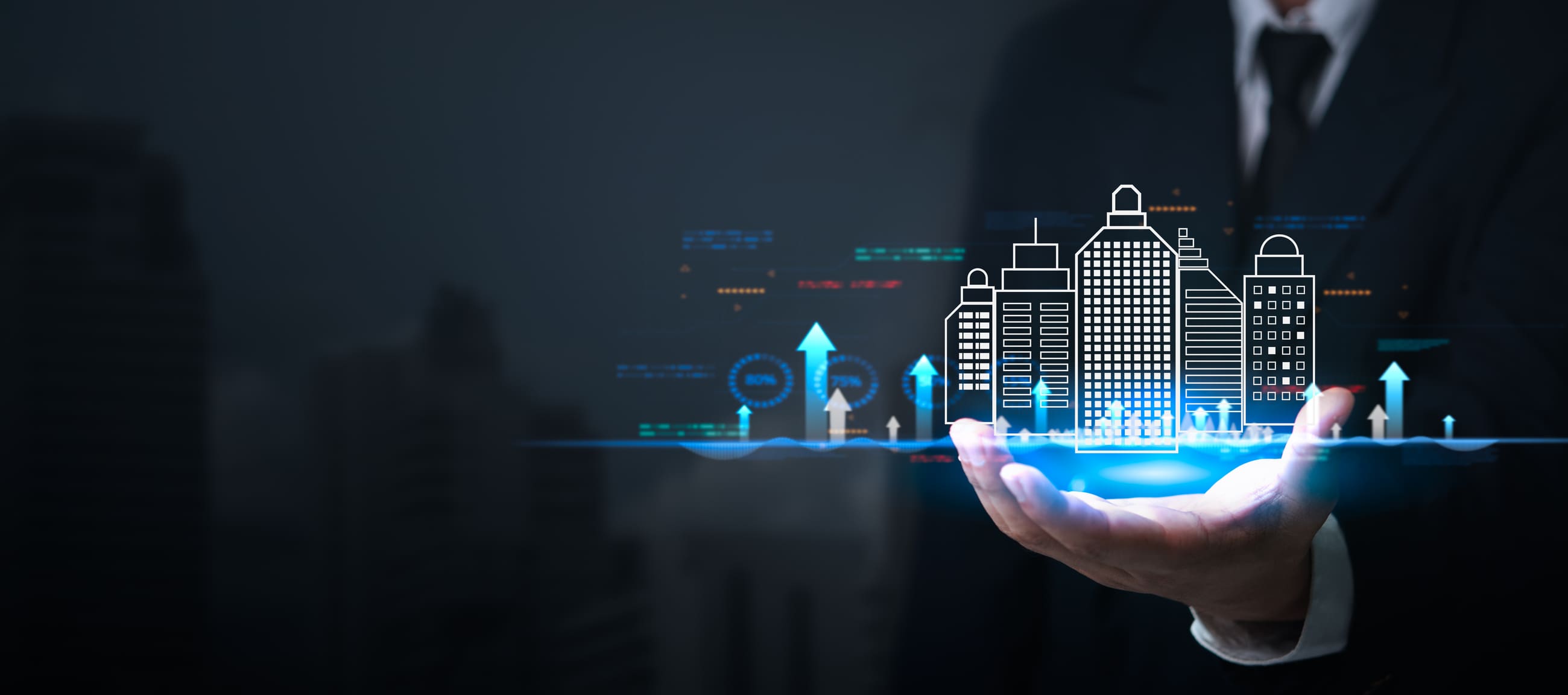 Businessman holding digital cityscape with graphs.