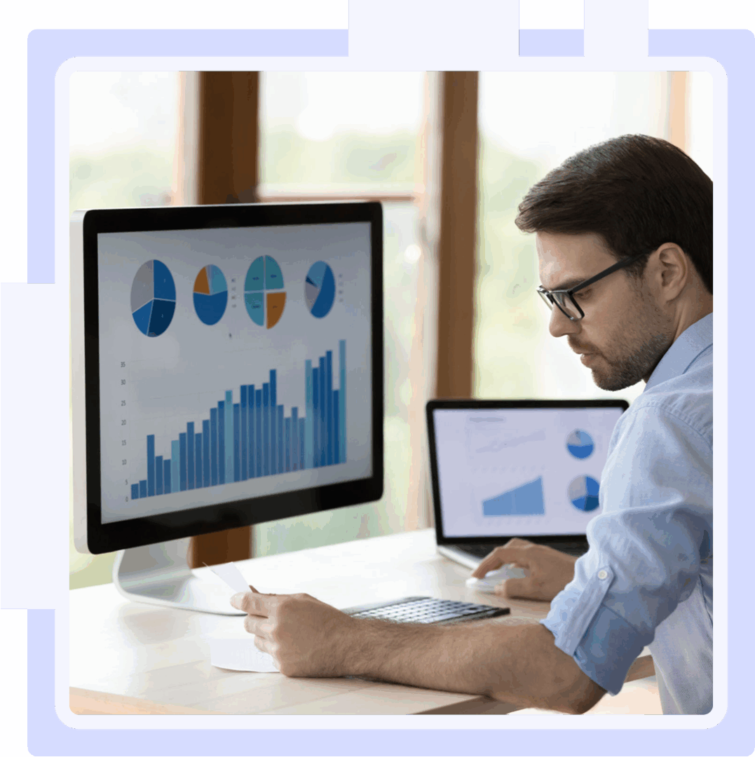 Man analyzing charts on computer screen.